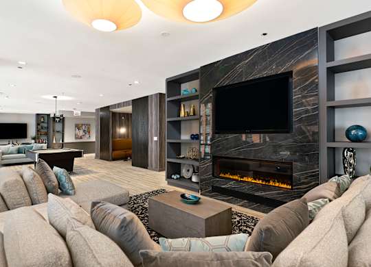 a living room with a large couch and a fireplace